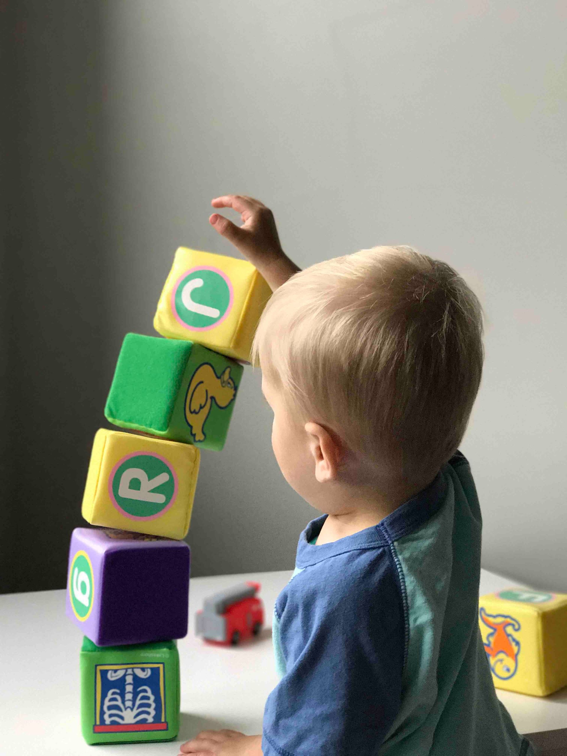 a young boy is using a phone